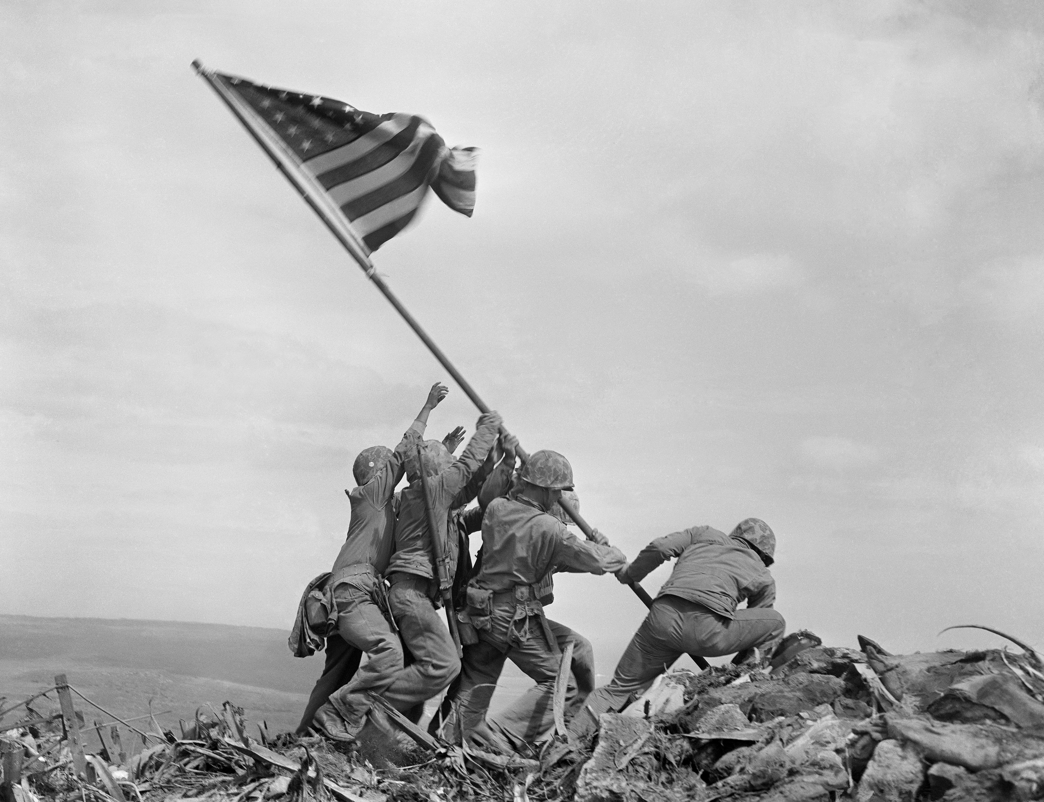 U.S. Marines raise a second, larger American flag atop Mt. Suribachi on the Japanese Island of Iwo Jima, Feb. 23, 1945. Three of the men in the photo were later killed in fighting on the island. This is the only photo to win the Pulitzer Prize in the year it was shot. (AP Photo/Joe Rosenthal)