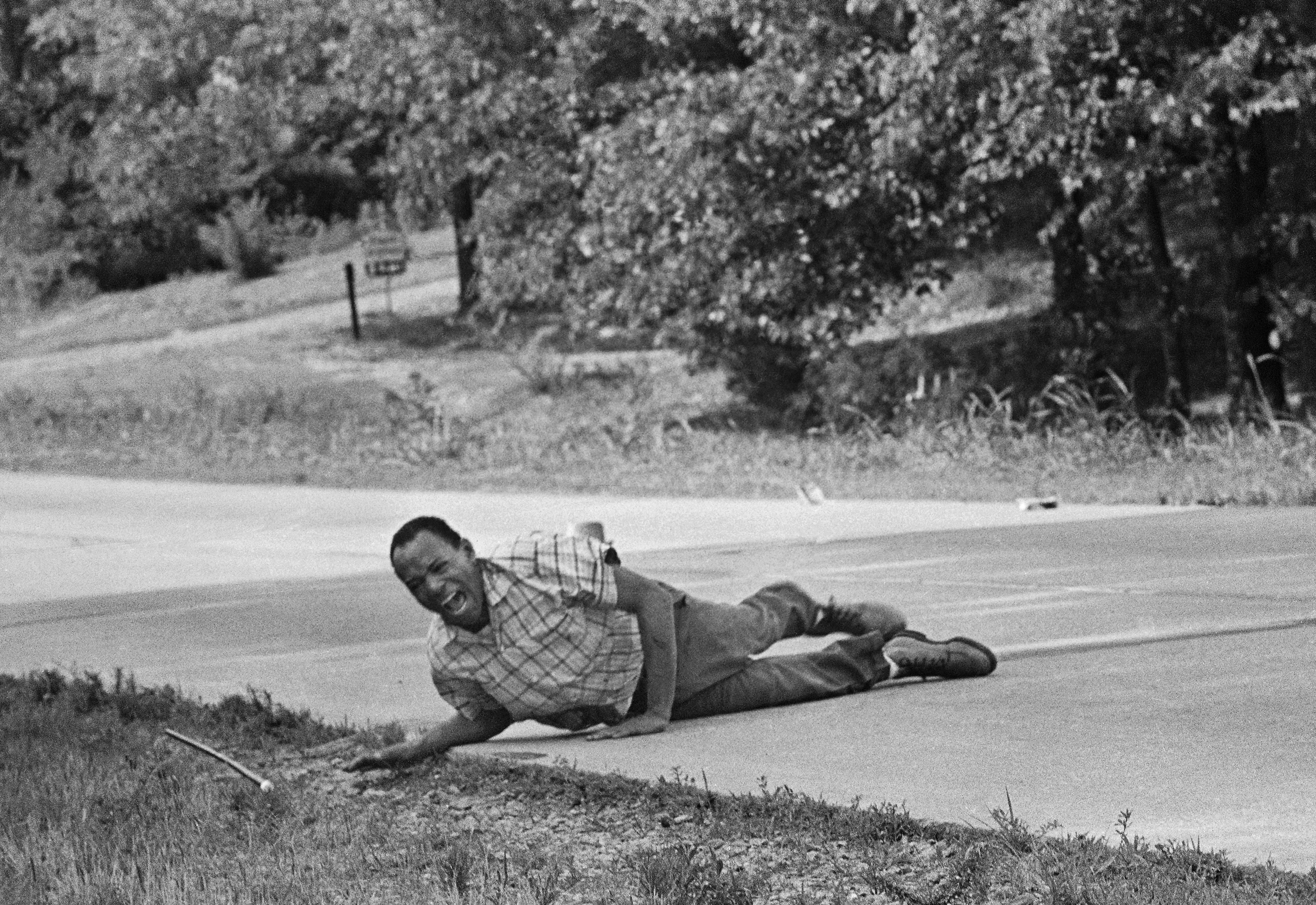 Civil rights activist James Meredith grimaces in pain as he pulls himself across Highway 51 after being shot in Hernando, Miss., June 6, 1966. Meredith was leading the March Against Fear to encourage African Americans to exercise their voting rights when he was shot. He completed the march from Memphis, Tenn., to Jackson, Miss., after treatment of his wounds. (AP Photo/Jack Thornell)