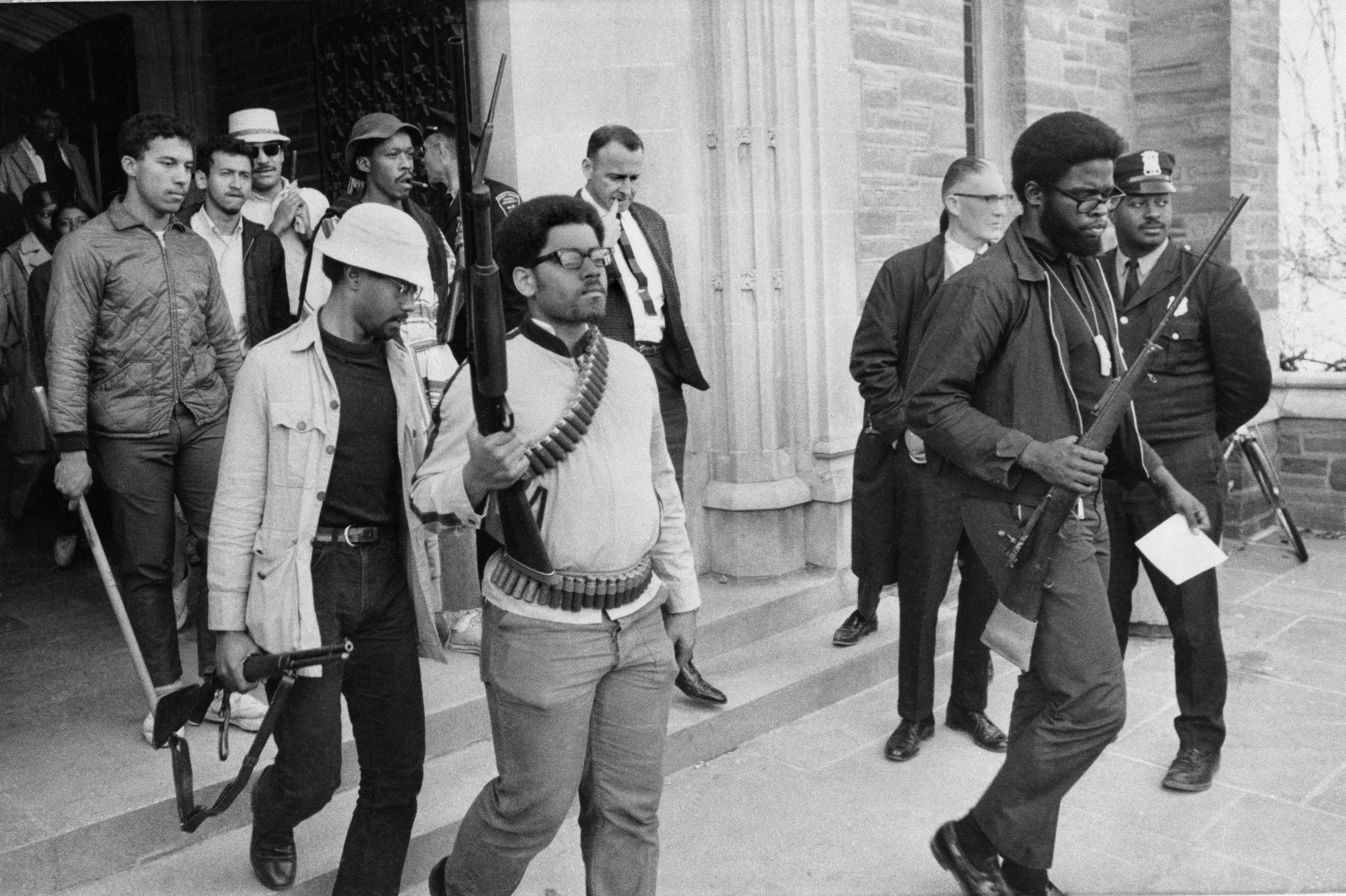 Armed students led by Ed Whitfield, far right, leave Straight Hall at Cornell University in Ithaca, N.Y., after a 36-hour sit-in, April 20, 1969. The students had barricaded themselves in the building demanding a degree-granting African American studies program. University administrators offered to drop some charges against the students and accelerate the opening of an African-American studies center. (AP Photo/Steve Starr)