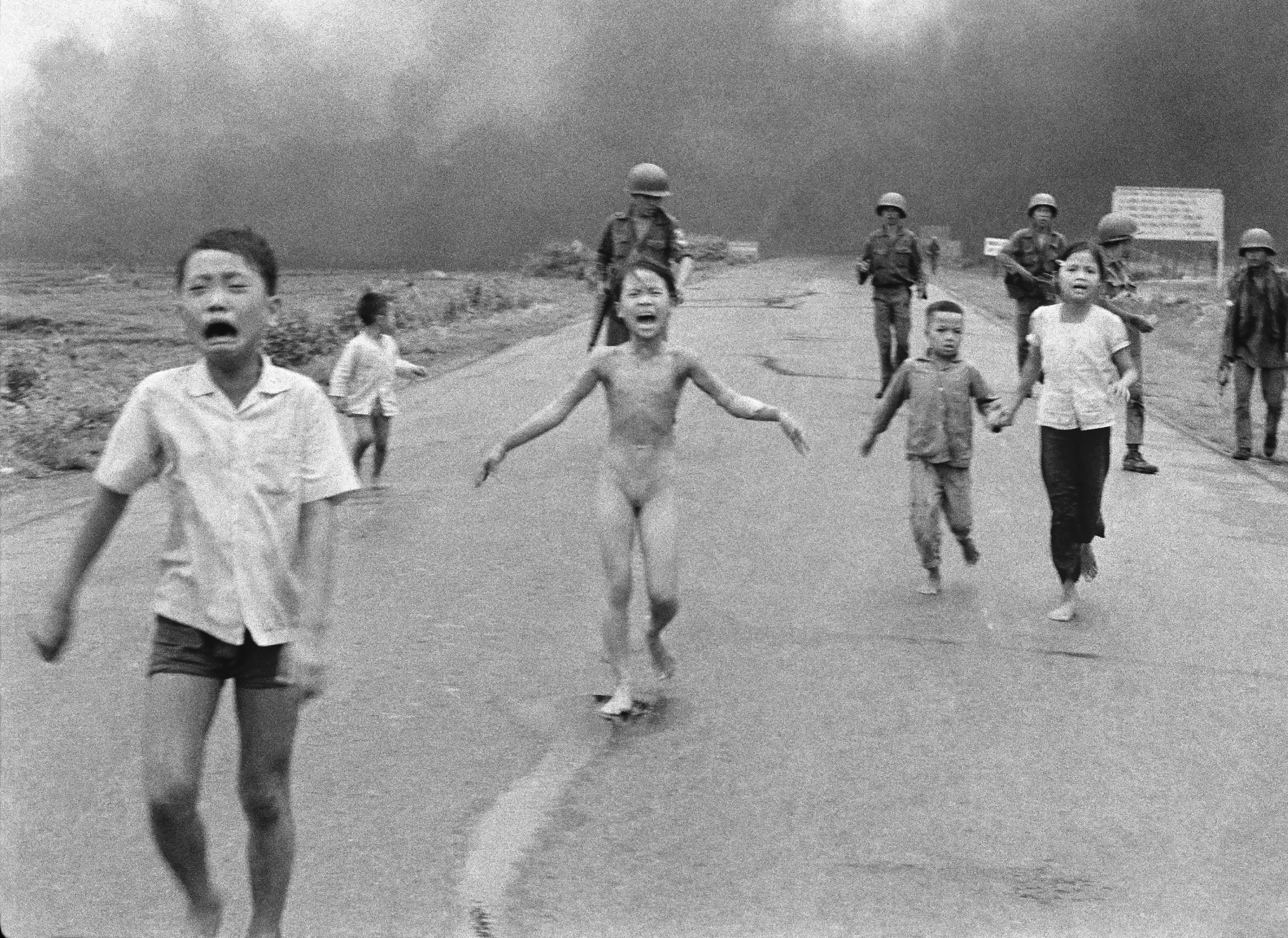 South Vietnamese forces follow after terrified children, including 9-year-old Kim Phuc, center, as they run down Route 1 near Trang Bang after an aerial napalm attack against suspected Viet Cong hiding places on June 8, 1972. Kim Phuc had ripped off her burning clothes after a South Vietnamese plane mistakenly dropped its incendiary bombs on South Vietnamese troops and civilians. The young girl is accompanied by her injured brothers and cousins; behind them are Vietnamese soldiers of the 25th Division. (AP Photo/Nick Ut)