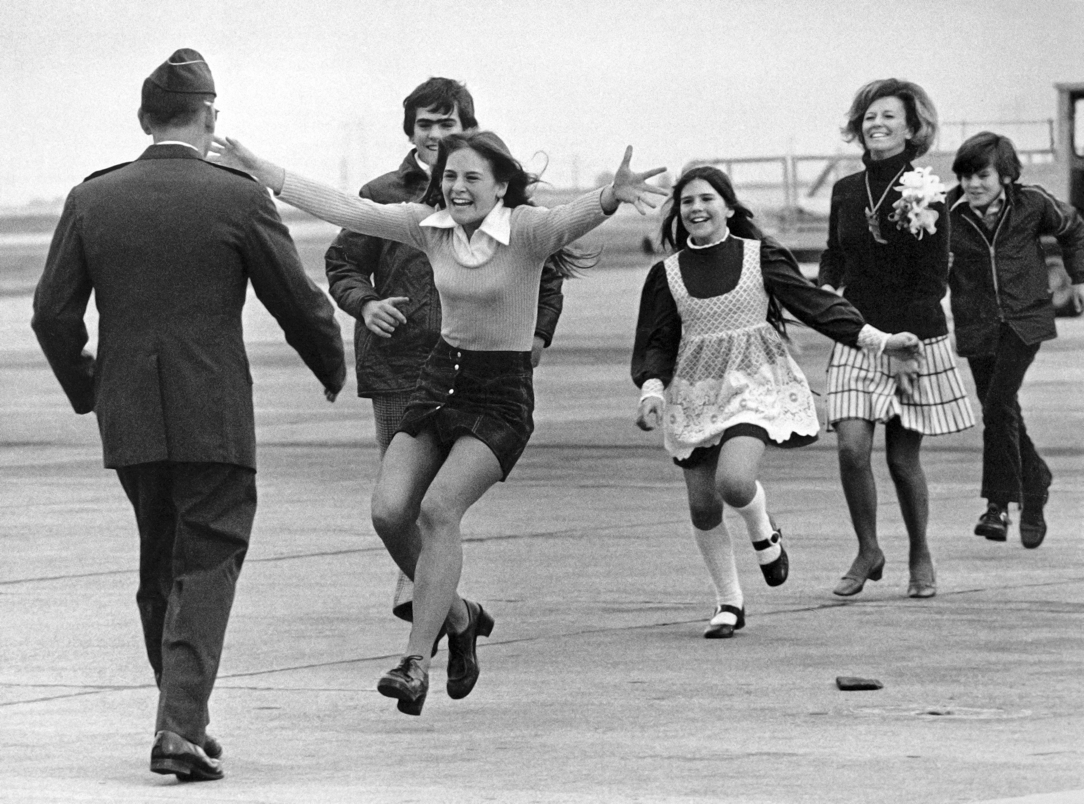Released prisoner of war Lt. Col. Robert L. Stirm is greeted by his family at Travis Air Force Base in Fairfield, Calif., as he returns home from the Vietnam War, March 17, 1973. Leading is Stirm's daughter Lori, 15, followed by son Robert, 14; daughter Cynthia, 11; wife Loretta and son Roger, 12. Stirm was held more than five years after his plane was shot down over North Vietnam in 1968. (AP Photo/Sal Veder)