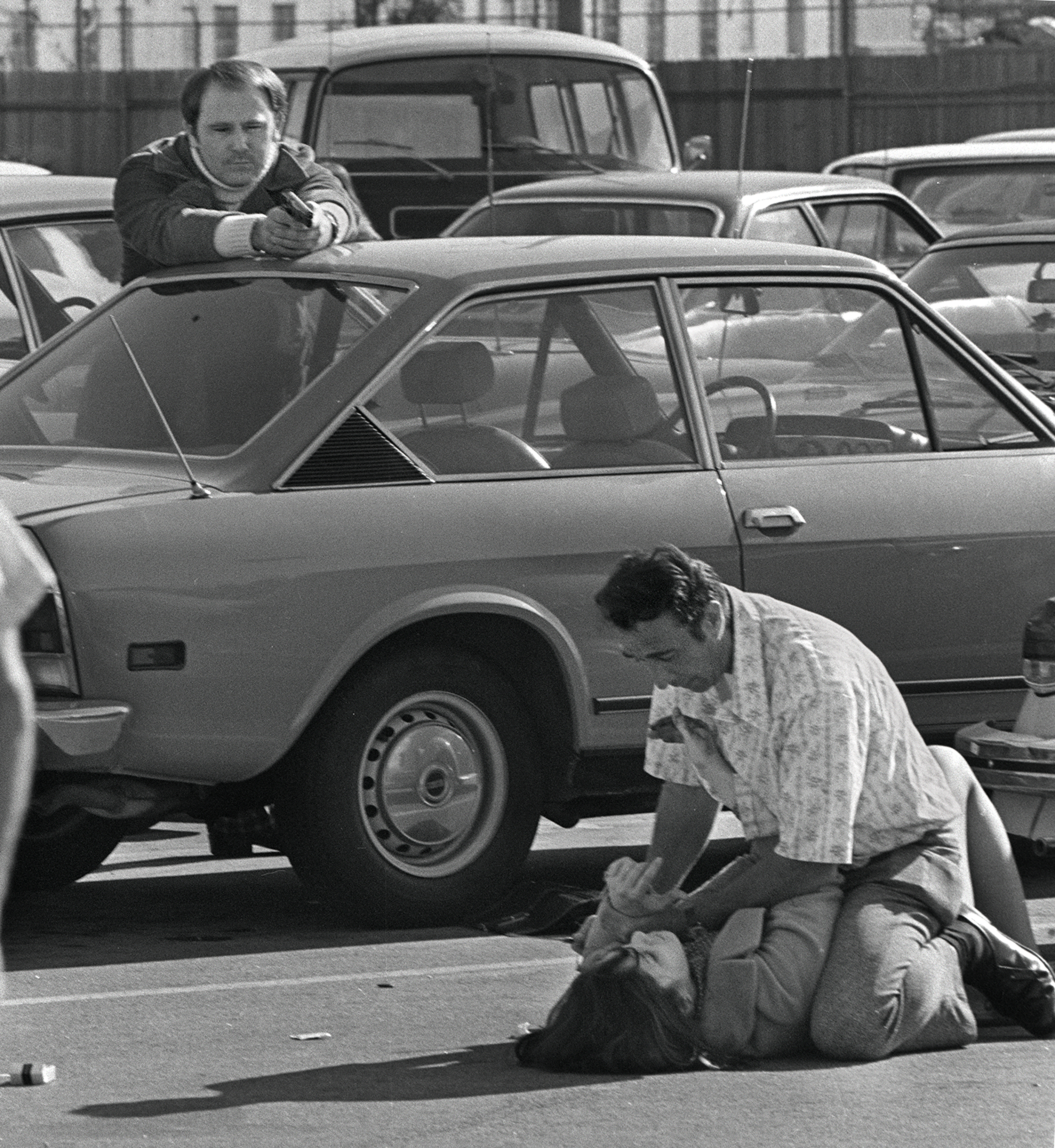 George H. Derby, left, a security guard, aims his gun at Edward F. Fisher, 39, who holds a knife to the throat of Ellen Sheldon, 22, during a kidnapping attempt in a Hollywood parking lot, Nov. 23, 1973. Sheldon managed to struggle to her feet, and seconds later Derby fired once after warning the suspect repeatedly. Fisher was killed instantly; Sheldon sustained minor injuries. (Anthony K. Roberts via AP)
