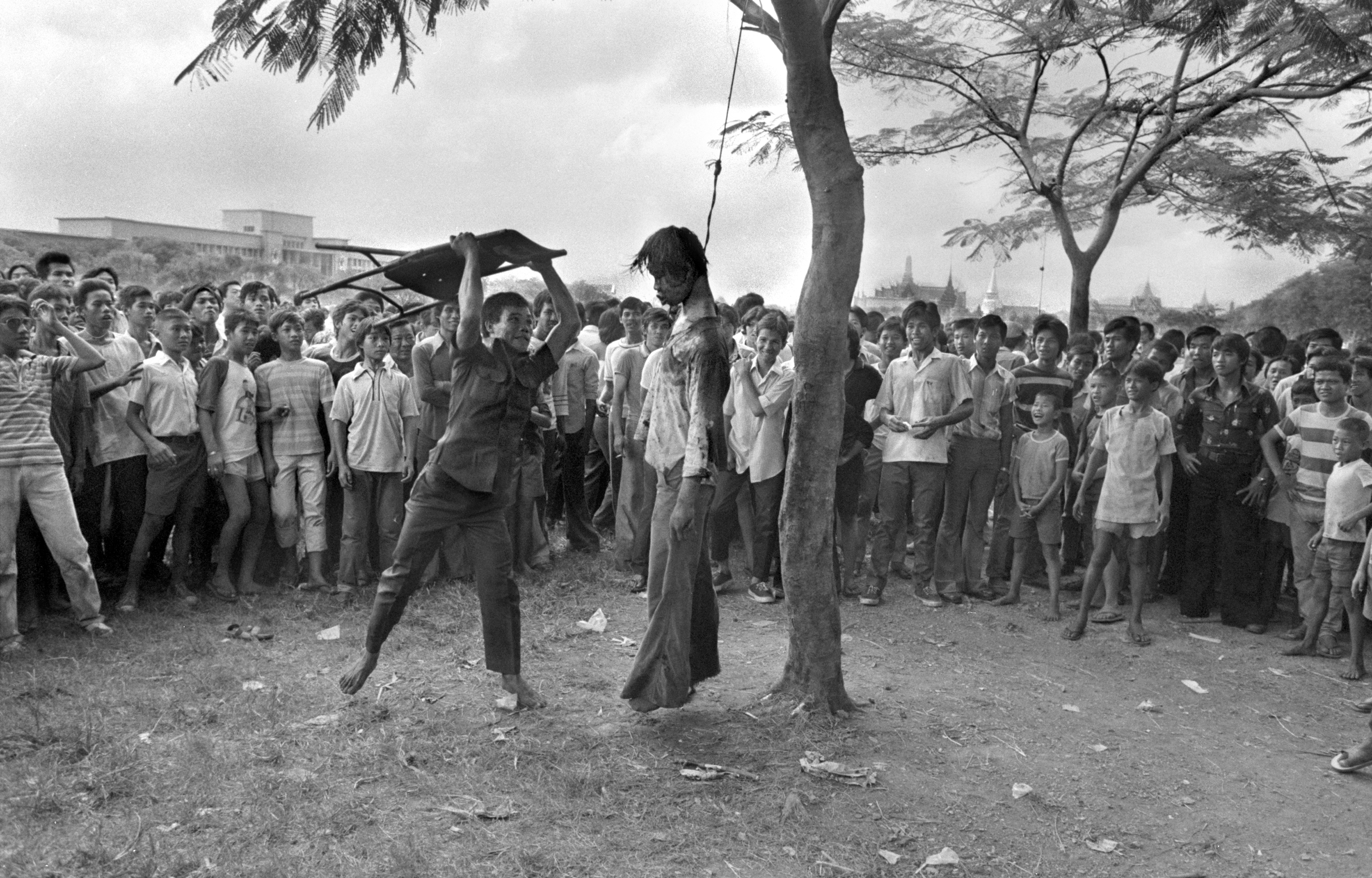A right-wing supporter strikes the lifeless body of a hanged student outside Thammasat University in Bangkok, Oct. 6, 1976. Police stormed the university after students demanded expulsion of a former military ruler and barricaded themselves in the school. (AP Photo/Neal Ulevich)