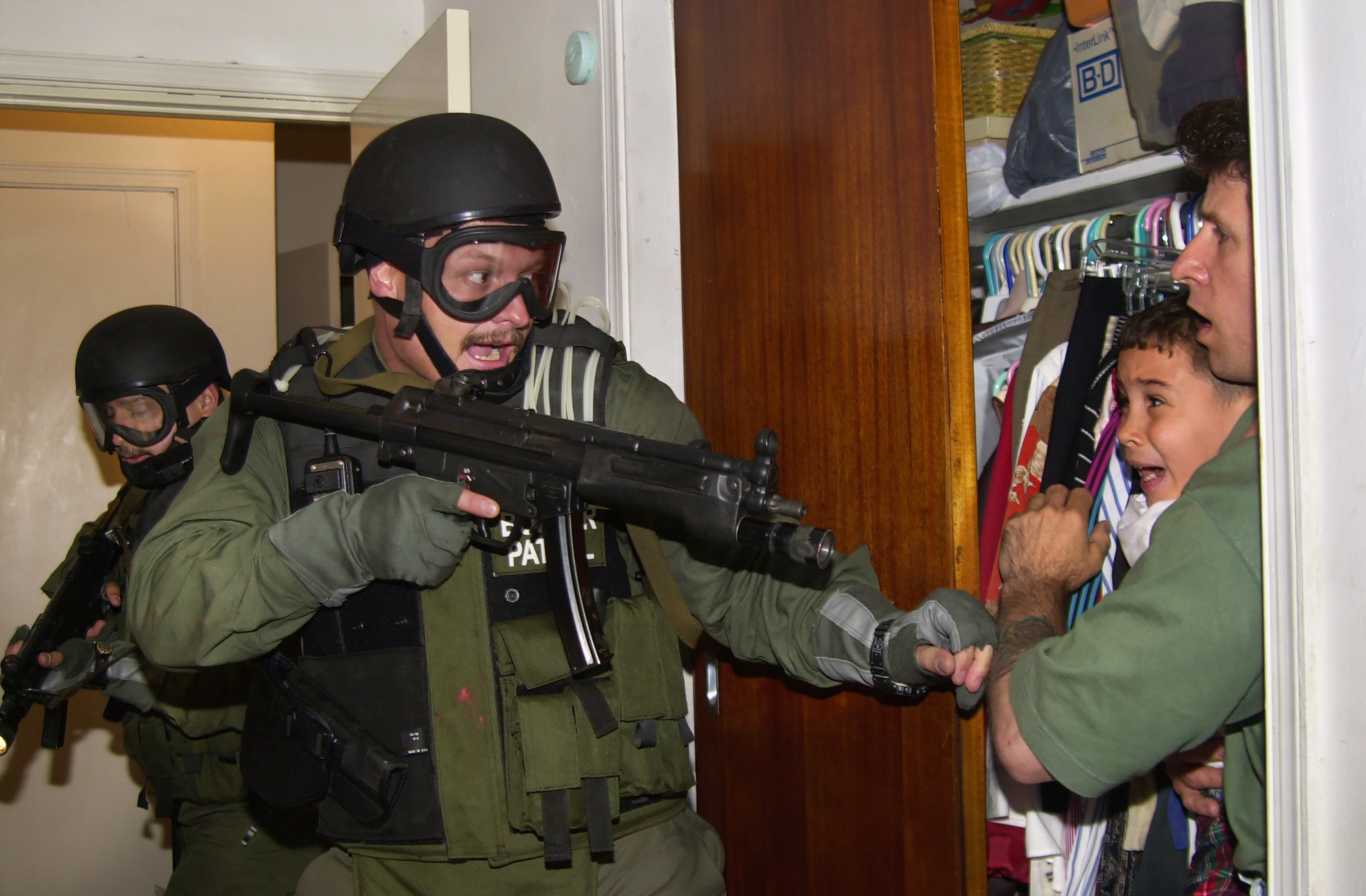Armed federal agents enter the bedroom of a home in Miami's Little Havana on April 22, 2000, as 6-year-old Elian Gonzalez is held in a closet by Donato Dalrymple, one of the two men who rescued the boy from the ocean months earlier. The agents took custody of Elian at the home of his Miami relatives, eventually repatriating him to Cuba with his father. (AP Photo/Alan Diaz)