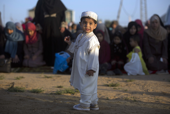A Palestinian boy attends Eid al-Fitr prayers in Gaza