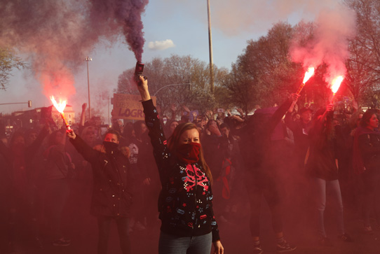 Women march holding flares in Madrid, Spain