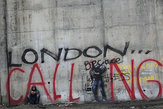 A cement wall with graffiti that says London Calling