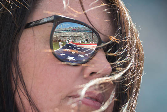 American flag is reflected in a volunteer's sunglasses. 
