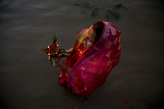 An Indian Hindu devotee performs rituals in the river Brahmaputra during Chhath Puja festival in in Gauhati, India, Saturday, Nov. 2, 2019. During Chhath, an ancient Hindu festival, rituals are performed to thank the Sun god for sustaining life on earth. (AP Photo/Anupam Nath)