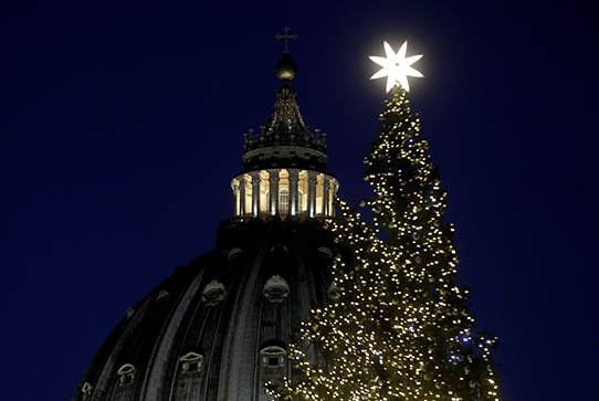 A Christmas tree is backdropped by the dome of St. Peter's Basilica during the ceremony of official lighting, at the Vatican, Thursday, Dec. 5, 2019. (AP Photo/Gregorio Borgia)
